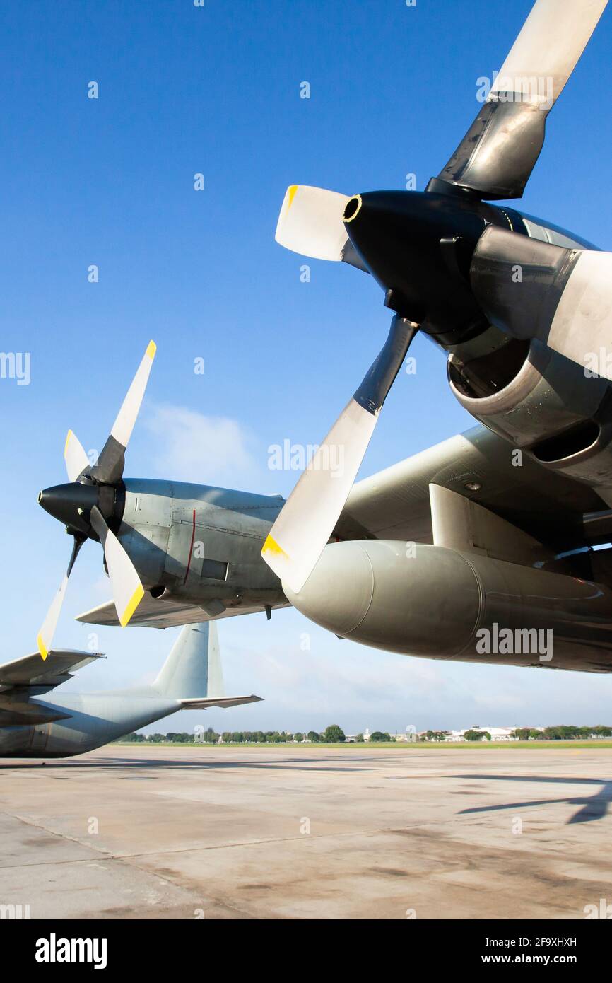 Military transport aircraft on runway at an airport in Asia, are primarily used to transport troops and war supplies. Stock Photo