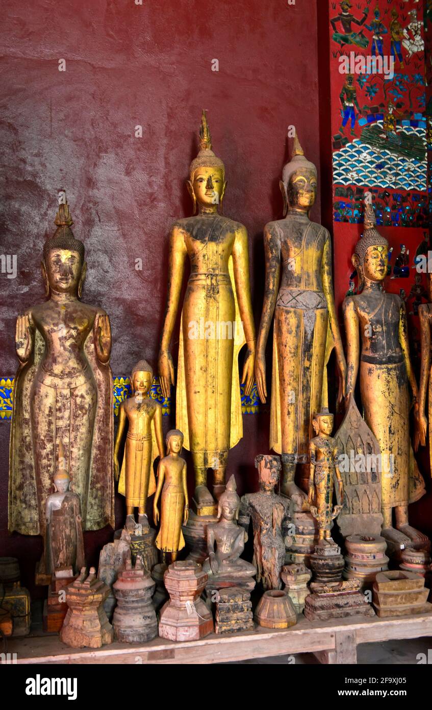 Standing Buddha Figures In Samabhanga Pose House Of The Royal Funeral Chariot, Wat Xieng Thong, Luang Prabang, Laos Stock Photo