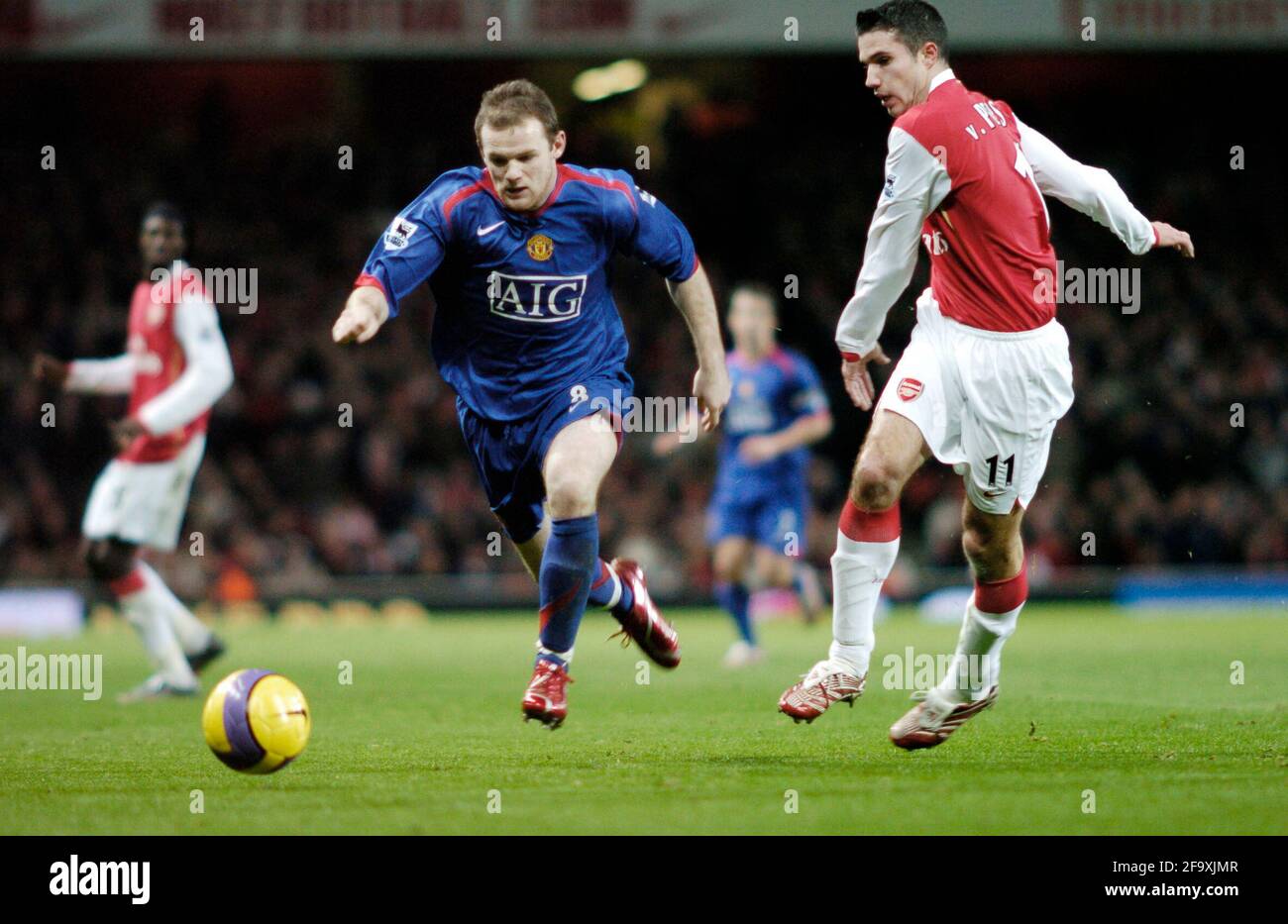 Manchester United's Wayne rooney Takes the ball past Robin Van Persie. Stock Photo