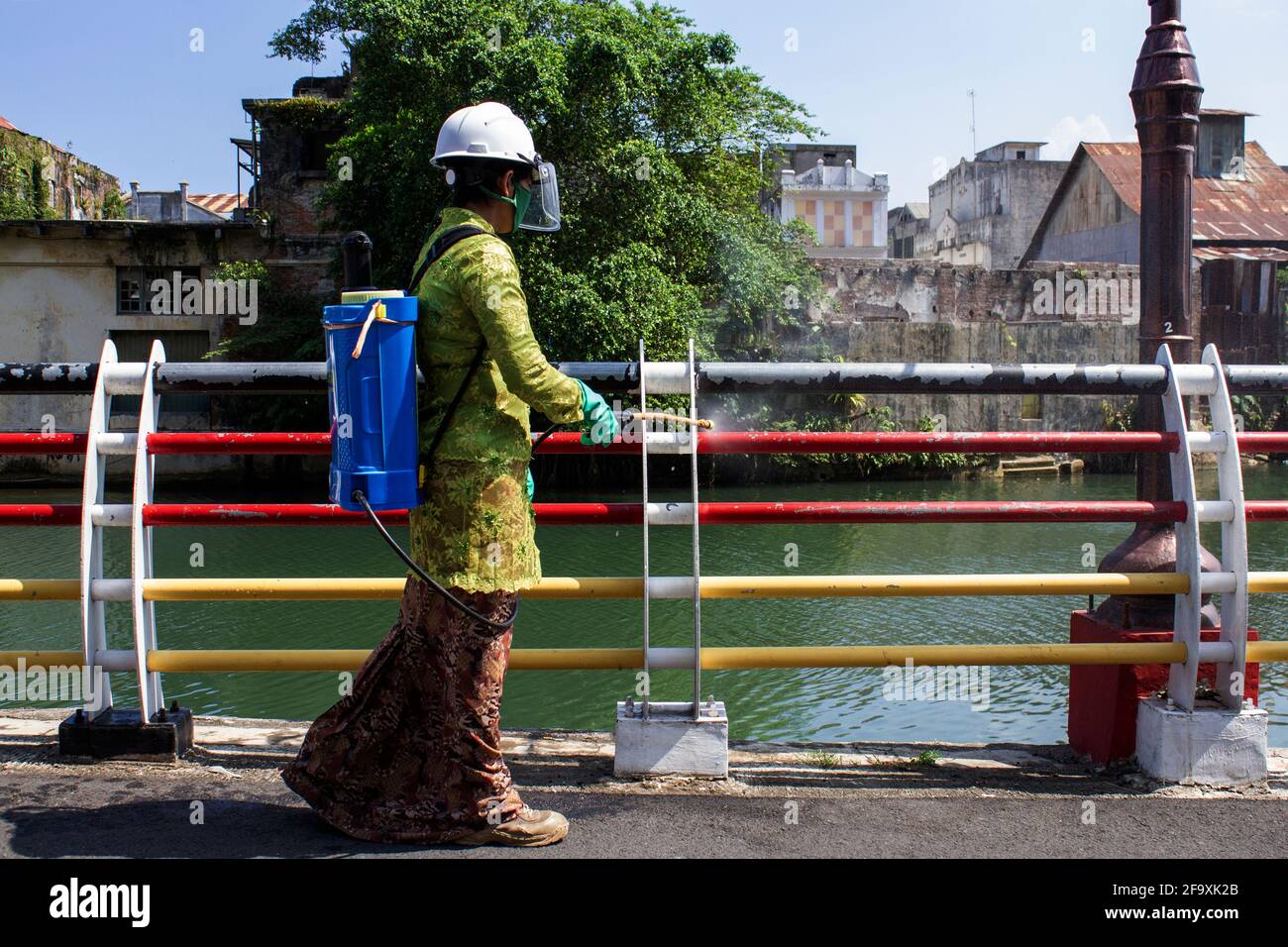 Padang, Indonesia, 21st April 2021. Women in Indonesia, Padang City, West Sumatra province wear the Kebaya to celebrate Kartini Day and spraying disinfectants on public roads in Batang Arau Village. Kariadil Harefa. Stock Photo