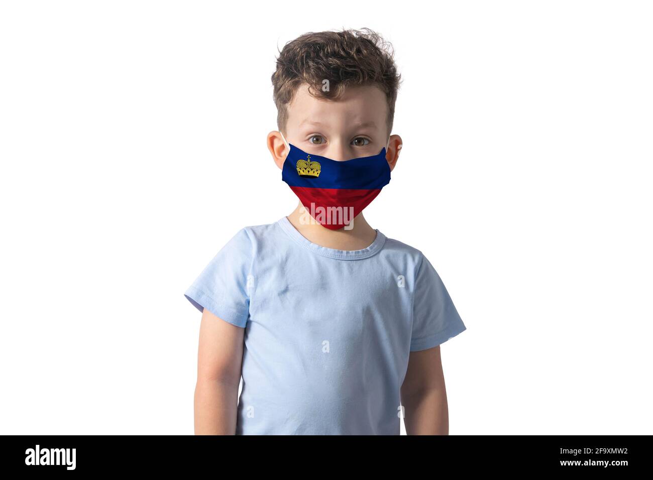 Respirator with flag of Liechtenstein. White boy puts on medical face mask isolated on white background. Stock Photo