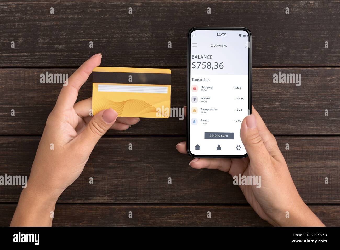 Unrecognizable woman holding credit card and smartphone with banking app Stock Photo