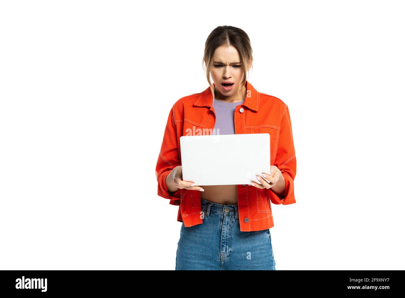 shocked young woman holding laptop isolated on white Stock Photo - Alamy
