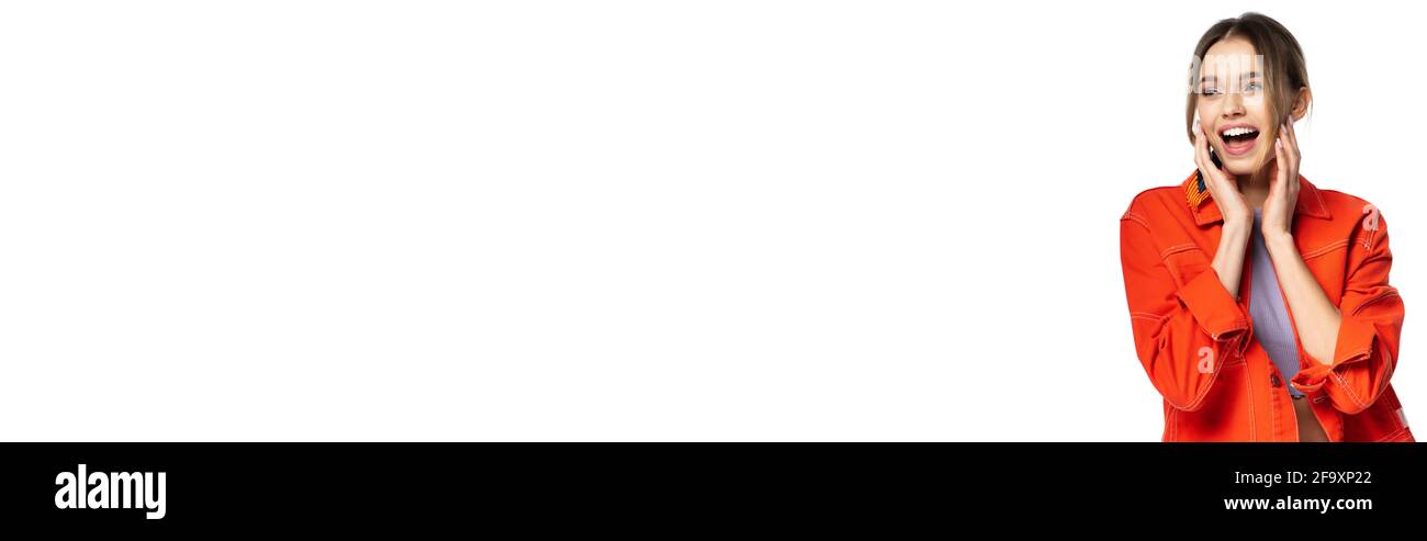 excited young woman in orange shirt laughing isolated on white, banner Stock Photo