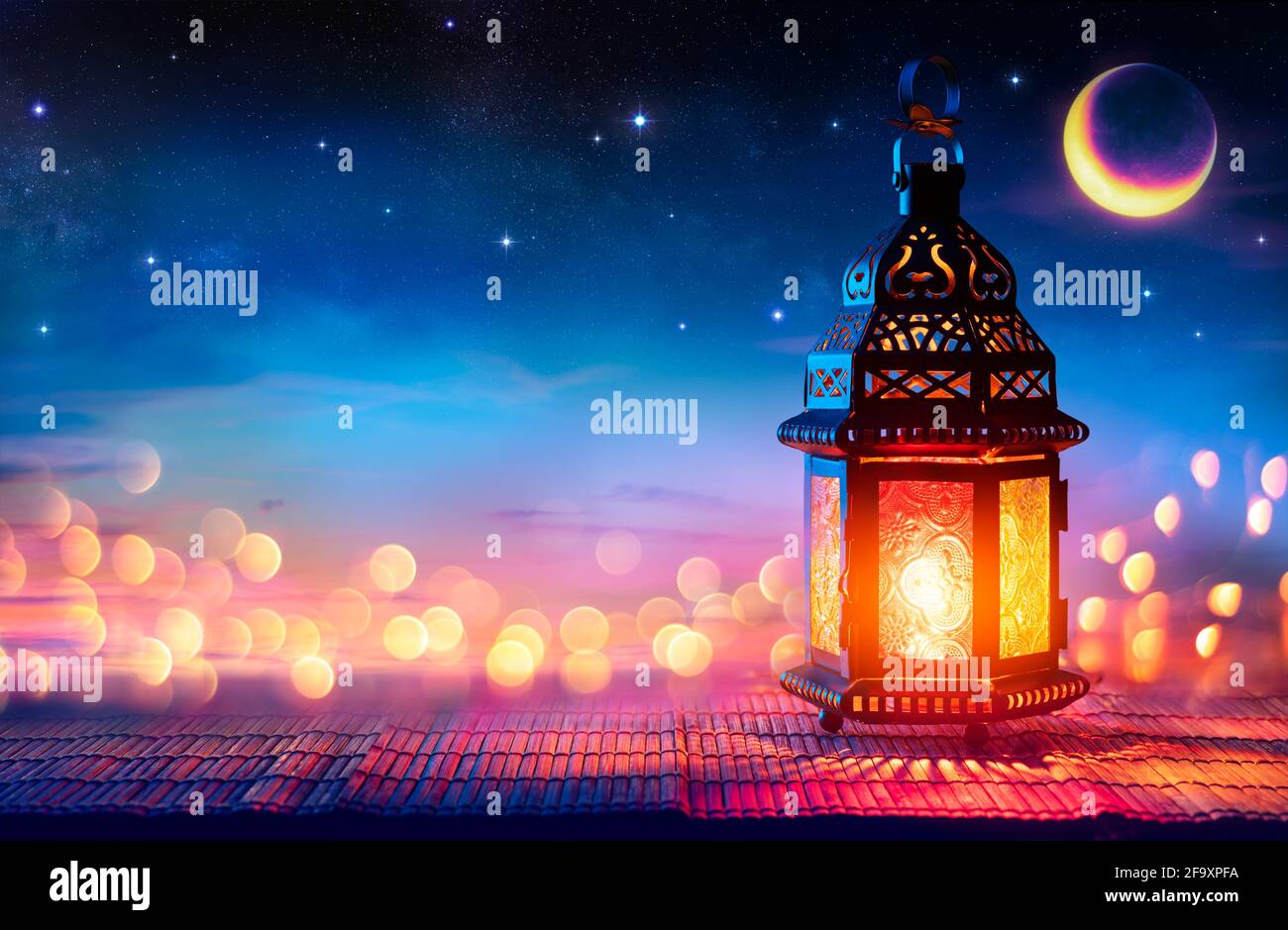 Muslim Holy Month Ramadan Kareem - Arabic Lantern With Burning Candle And Bokeh Glowing At Evening - Eid Ul Fitr Stock Photo