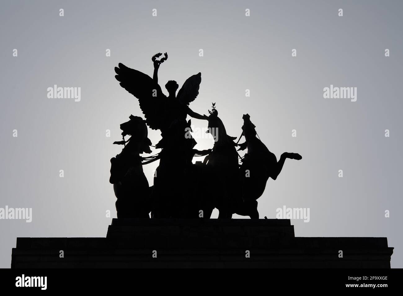 London, UK - 20 Apr 2021: The bronze quadriga thats sits atop of Wellington Arch in Hyde Park Corner, silhouetted against the morning sun. Stock Photo