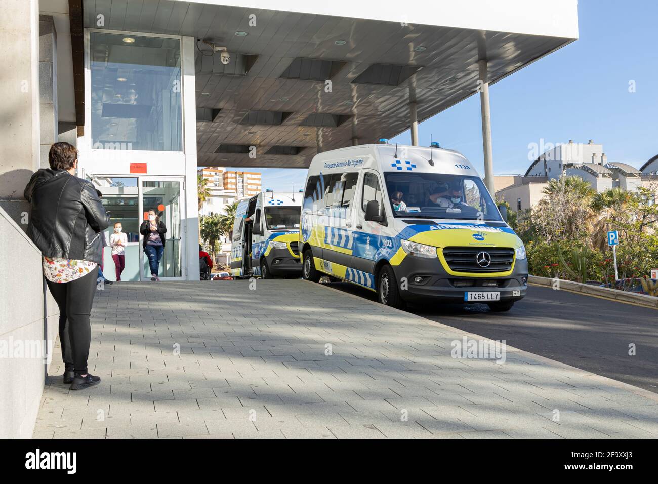 Non urgent ambulance transport mini buses waiting at the main entrance to the Hospital Universatorio Canarias in Santa Cruz, Tenerife, Canary Islands, Stock Photo