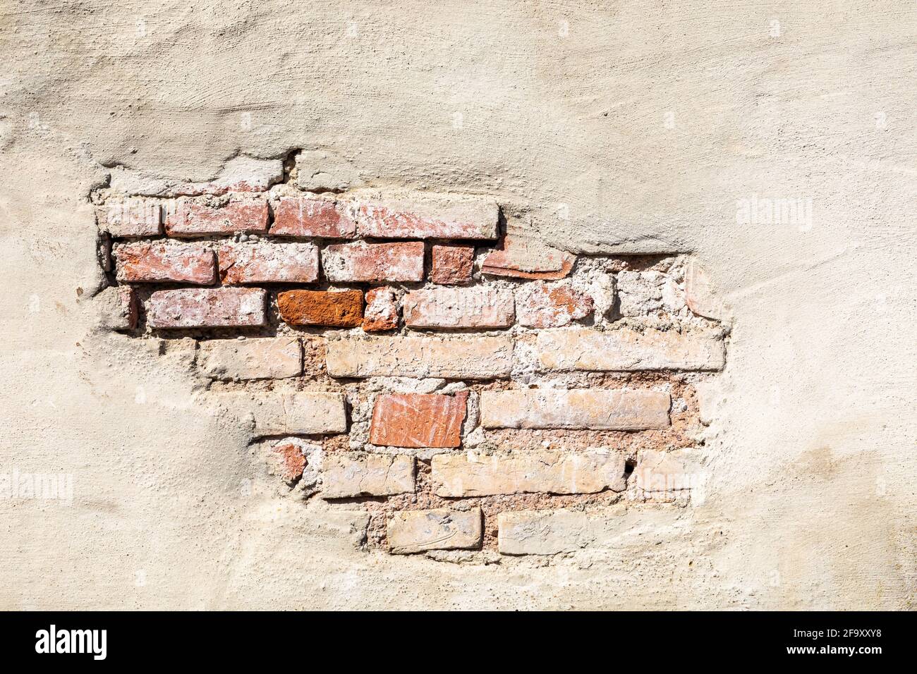 Old wall with crumbled plaster Stock Photo