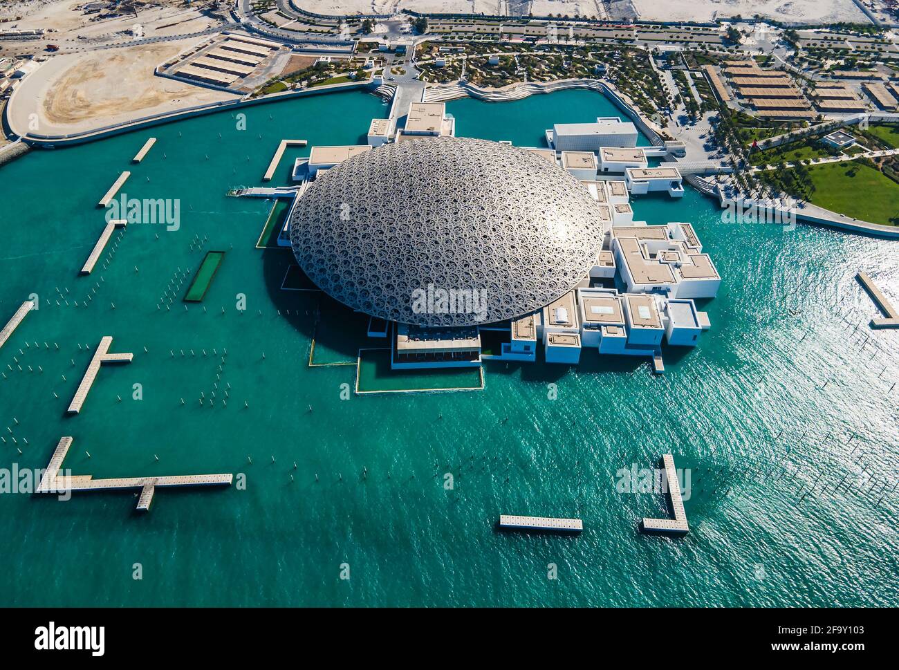 Abu Dhabi, United Arab Emirates - April 6, 2021: Louvre museum in Abu Dhabi emirate of the United Arab Emirates at sunrise aerial drone view of the bu Stock Photo