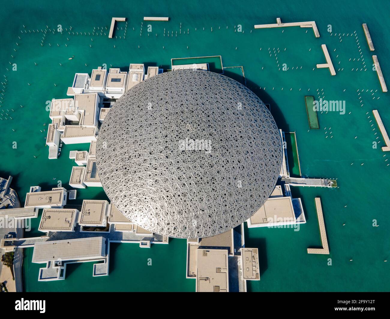 Abu Dhabi, United Arab Emirates - April 6, 2021: Top view of Louvre museum in Abu Dhabi emirate of the United Arab Emirates at sunrise aerial drone vi Stock Photo