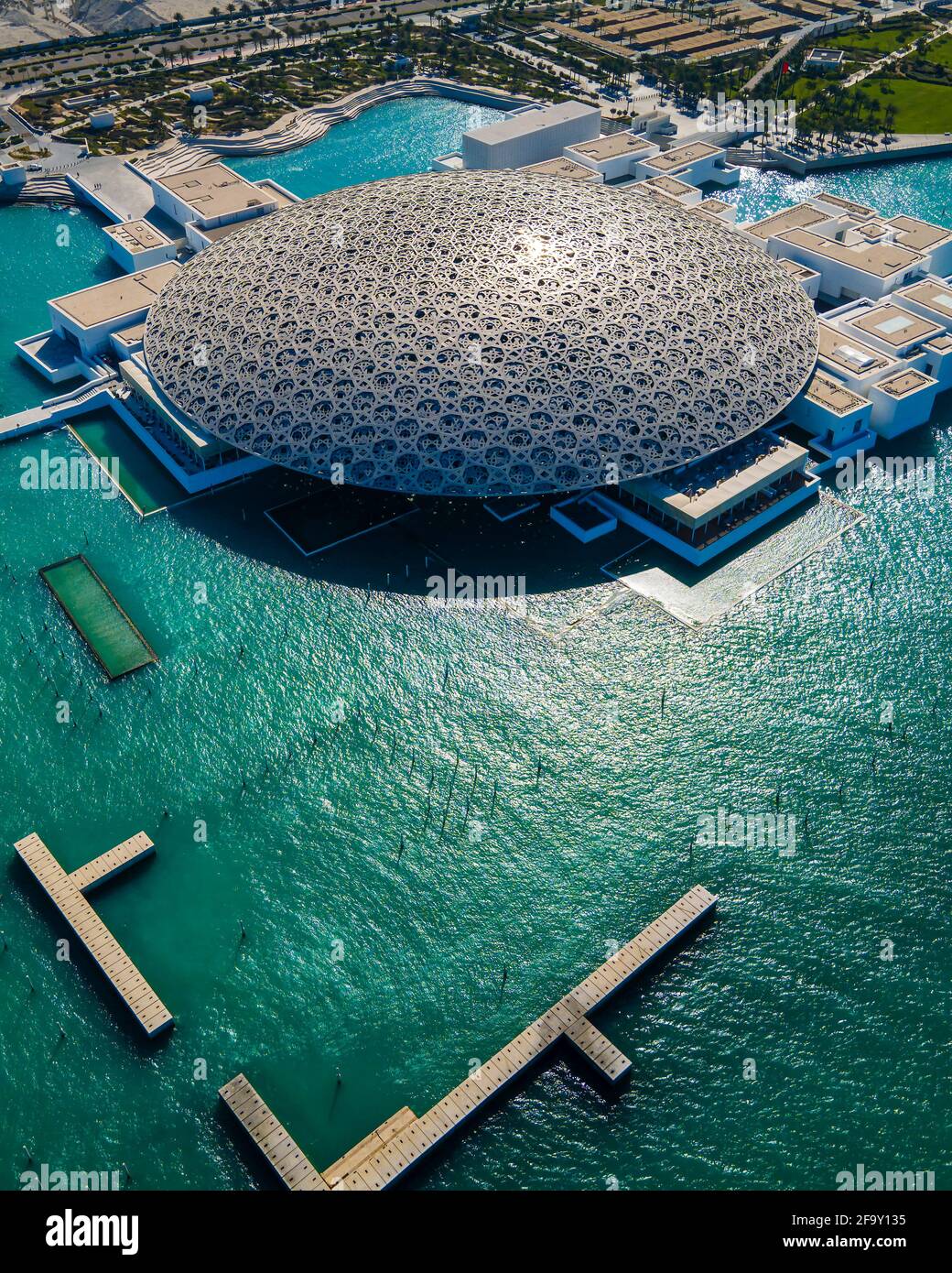 Abu Dhabi, United Arab Emirates - April 6, 2021: Louvre museum in Abu Dhabi emirate of the United Arab Emirates at sunrise aerial drone view of the bu Stock Photo