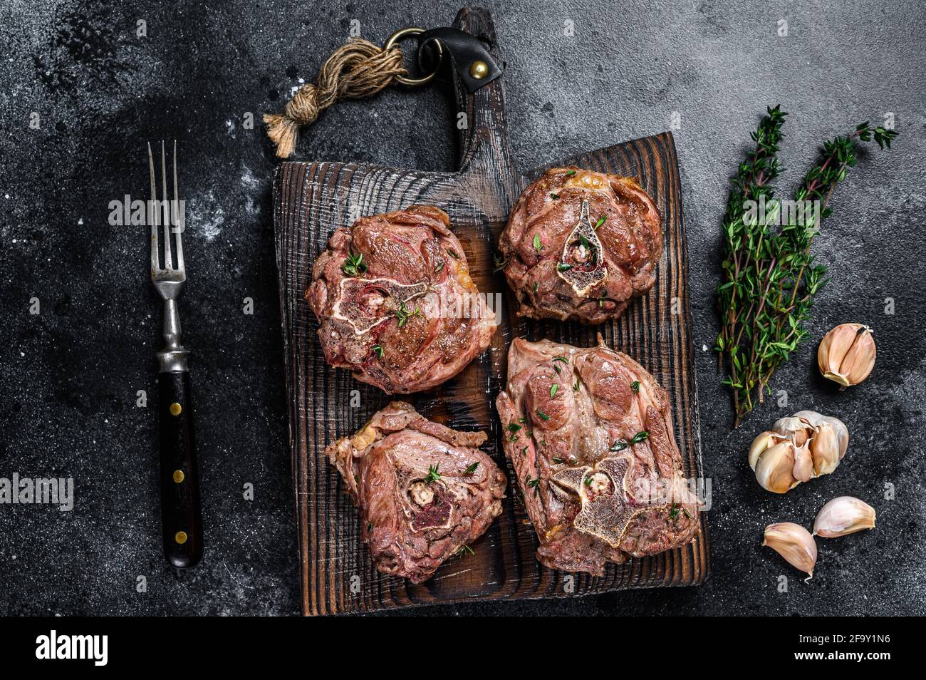 Grilled Lamb Neck Meat Steaks On A Wooden Board With Herbs Black Background Top View Stock Photo Alamy