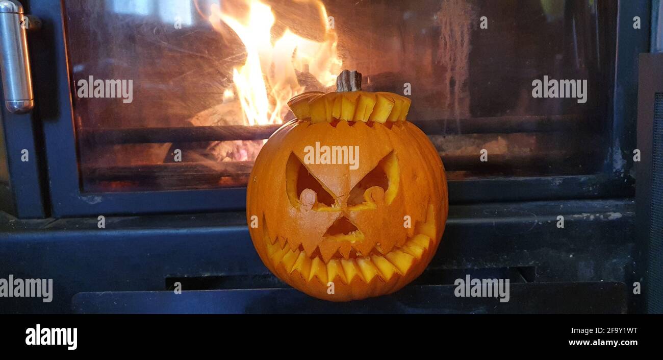 pumpkin carved for halloween with the background fireplace flames Stock ...