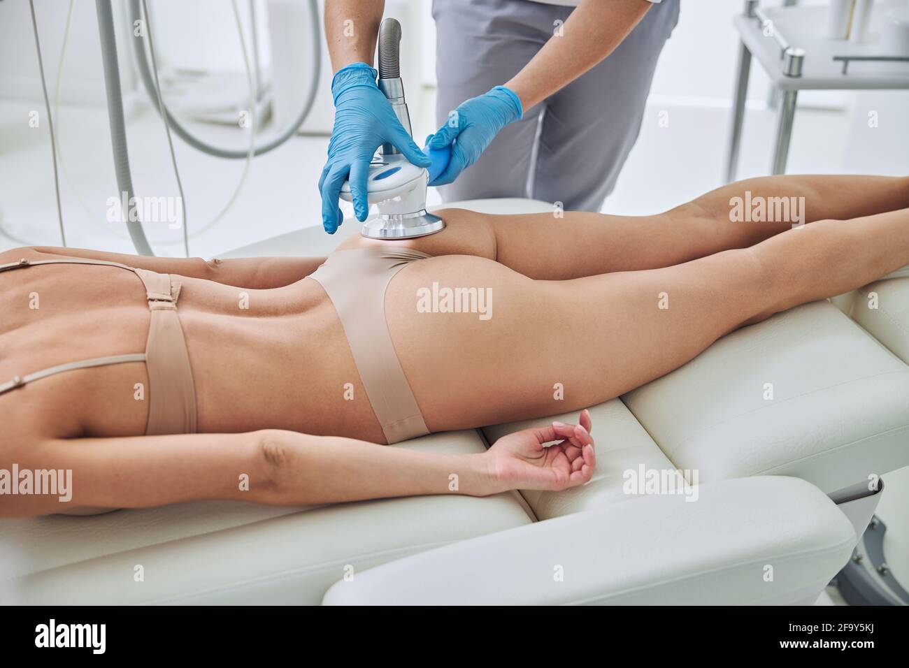 Image of ultrasound cavitation body contouring treatment in wellness center Stock Photo