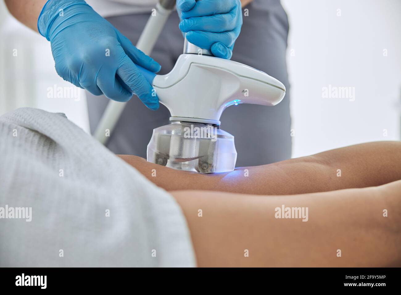 Unrecognized female client receiving anti-cellulite and anti-fat therapy in beauty clinic Stock Photo