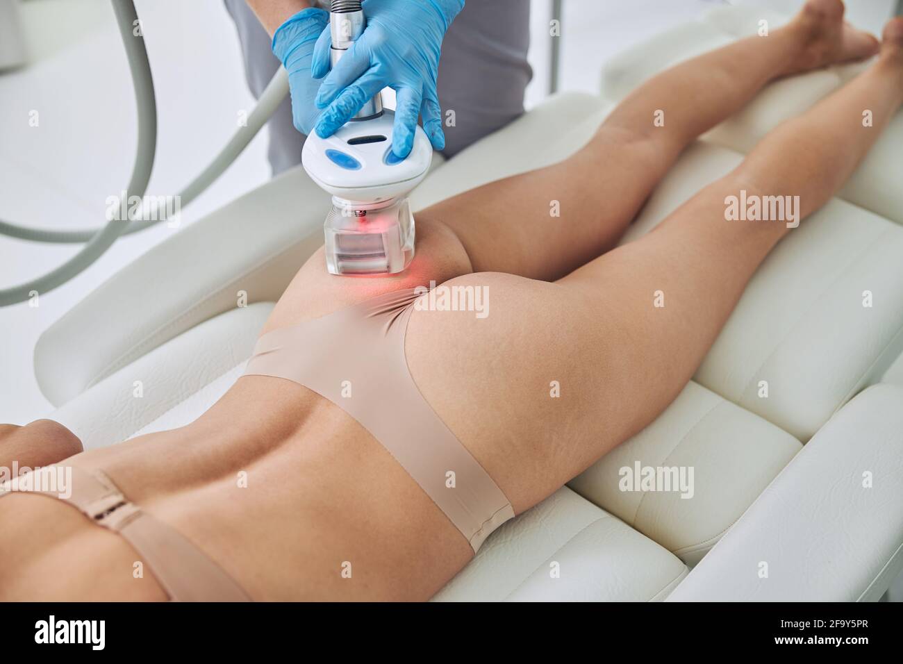 Woman with beautiful body receiving anti-cellulite and anti-fat therapy in spa salon Stock Photo