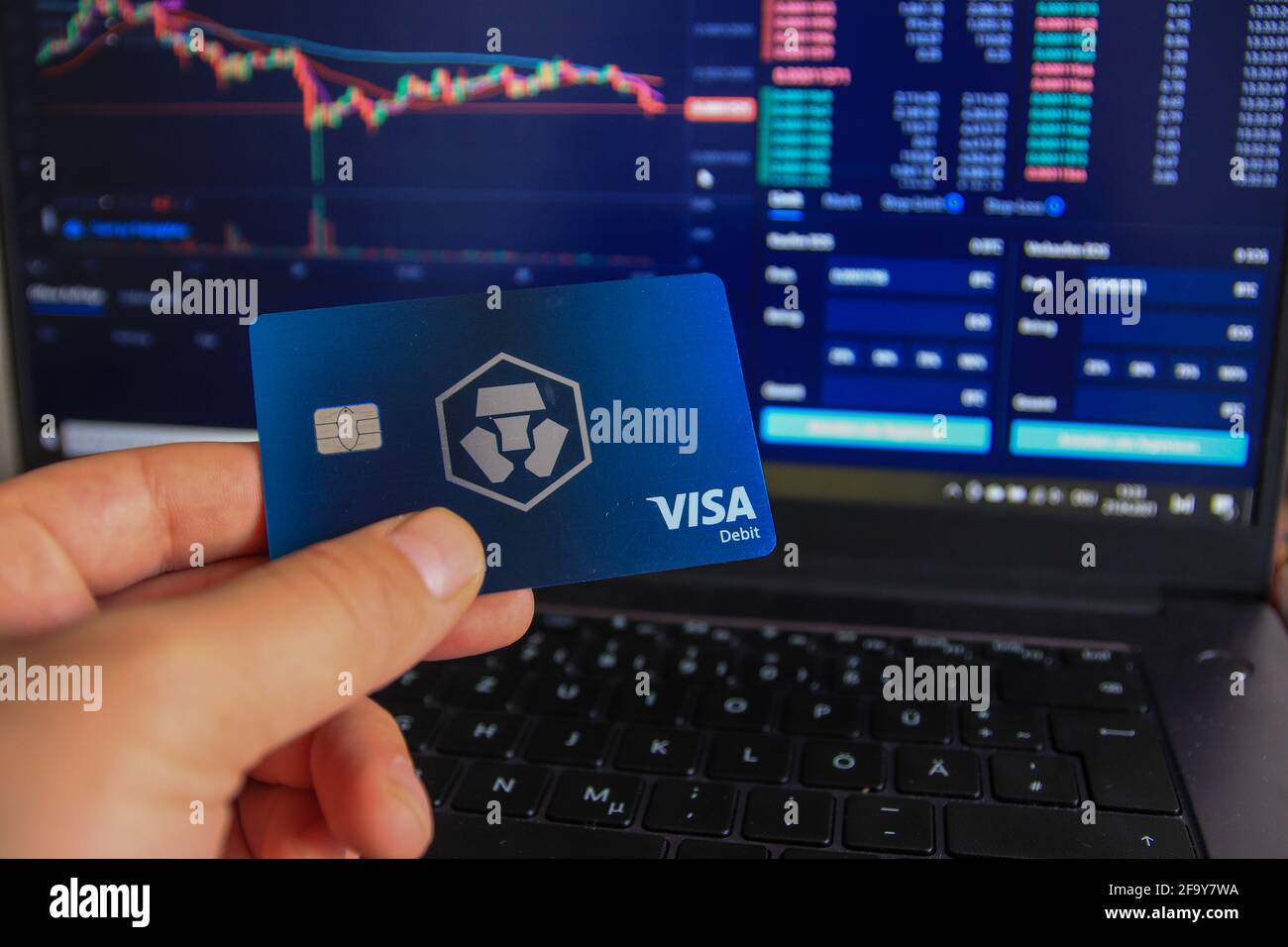 Berlin, Germany - April 21, 2021: Man holding Crypto.com debit card in hand. Crypto.com is a beginner-friendly crypto trading platform . Stock Photo