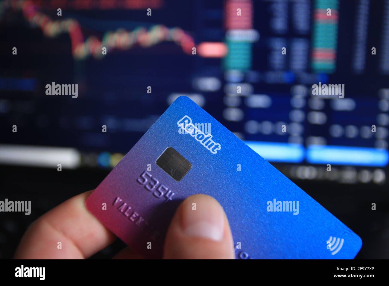 Berlin, Germany - April 21, 2021: Man holding Revolut debit card in hand.  Revolut is a fast, simple, and easy way to buy, sell, and hold  cryptocurrenc Stock Photo - Alamy