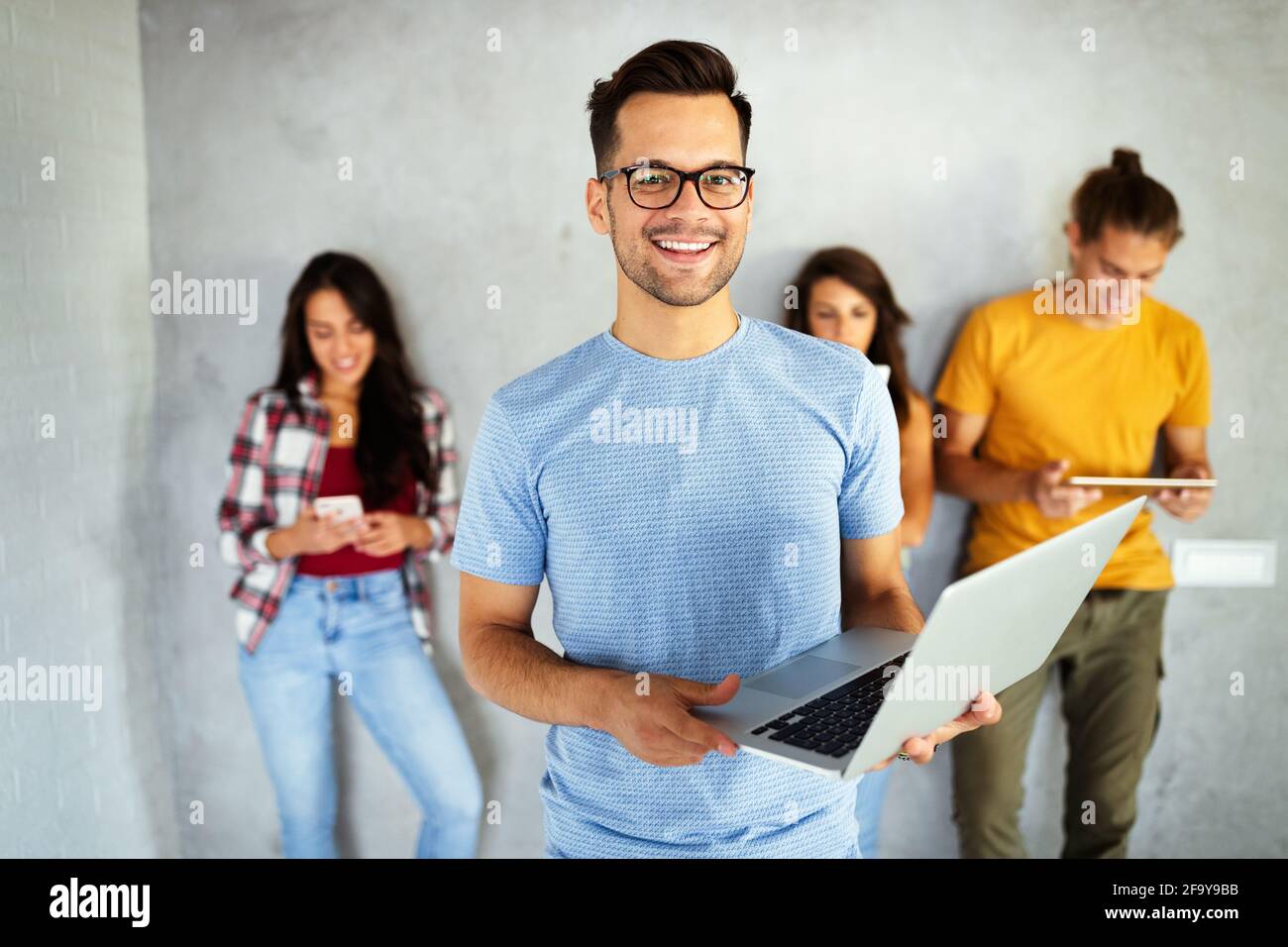 Happy young people working, using digital devices. Technology, people ...