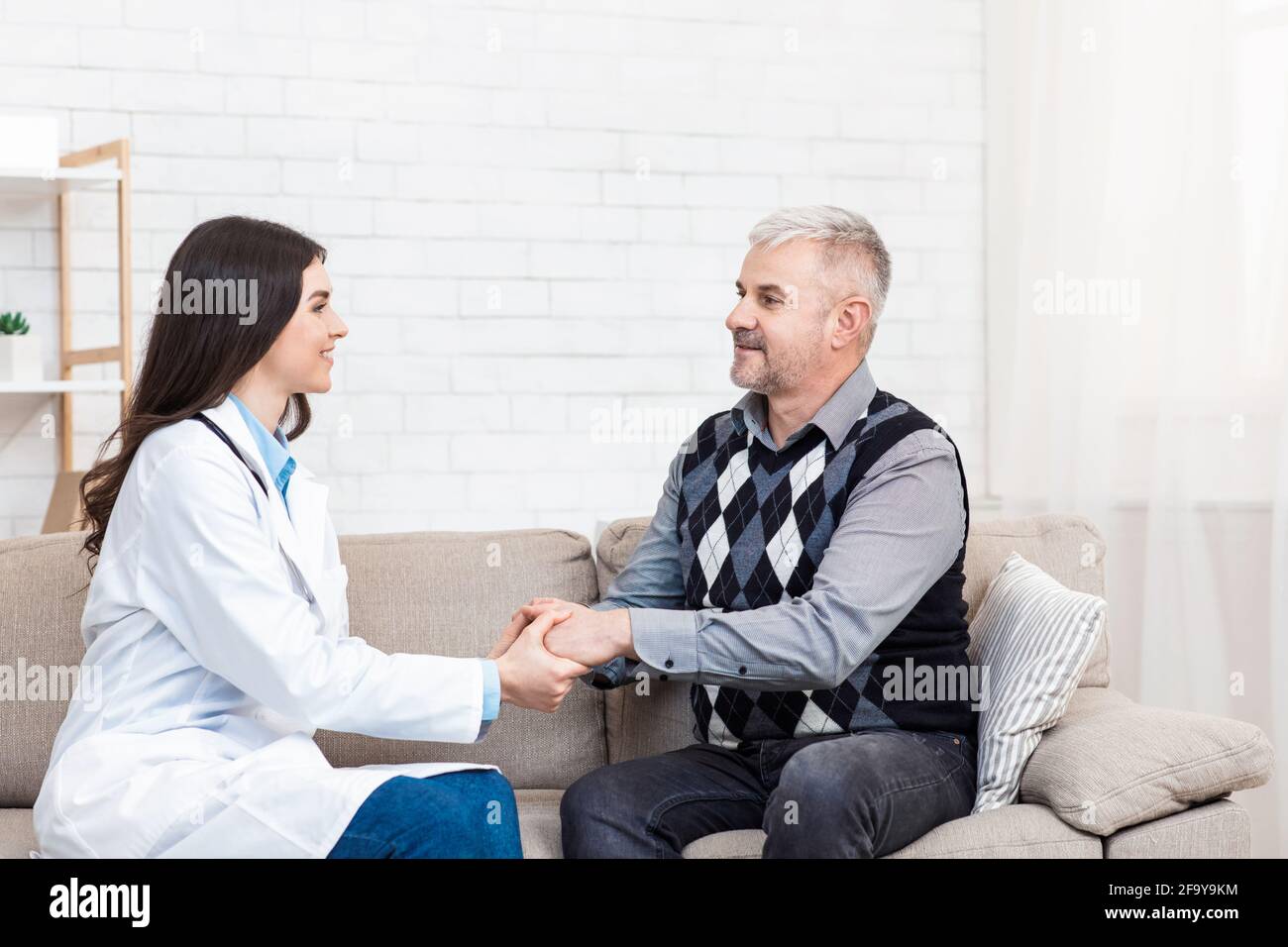 Good doctor, thanks to therapist in modern clinic, consultation, exam and health care Stock