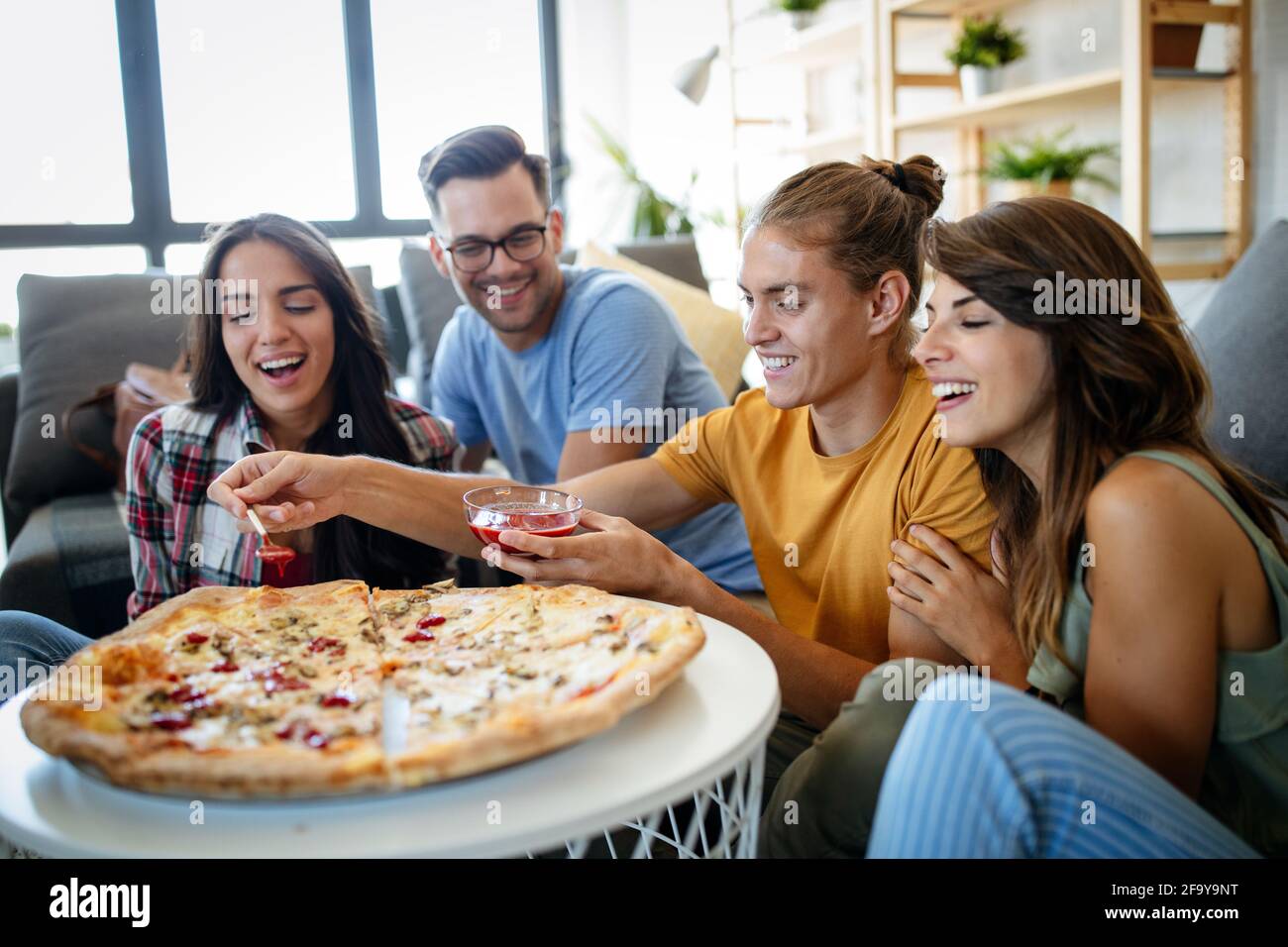 Friends enjoying pizza party Stock Photo by Rido81