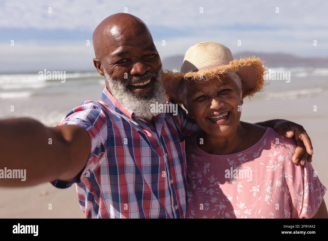 Portrait of happy senior african american couple taking a selfie at the ...