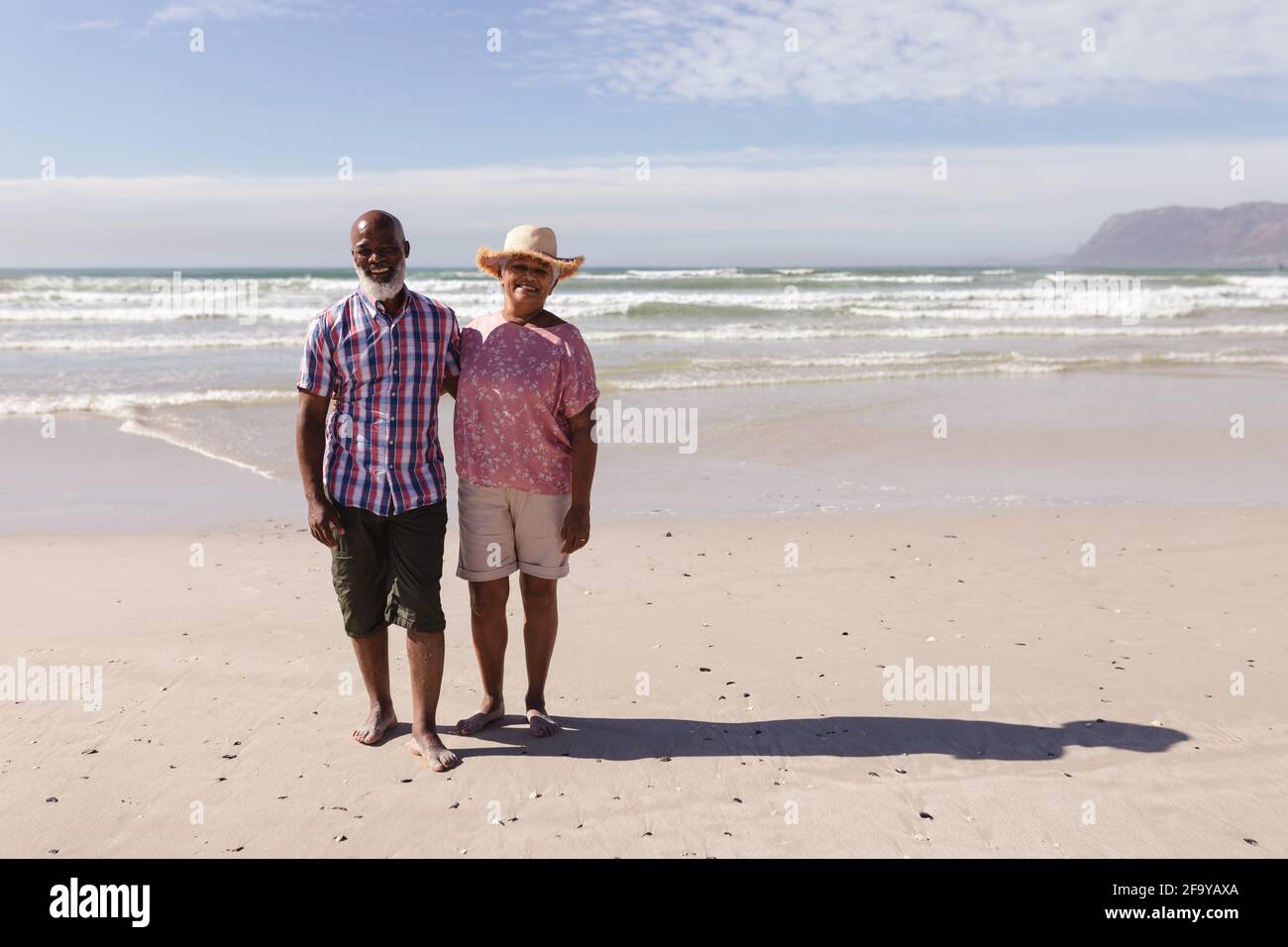 Portrait of happy senior african american couple standing on the beach ...
