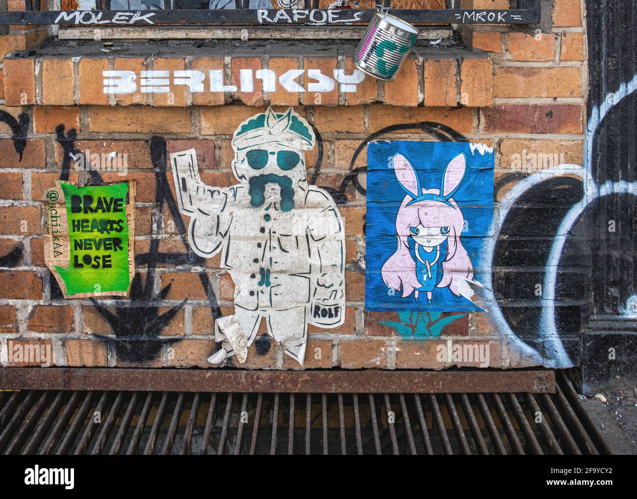 Informal gallery.Brick surface of railway viaduct with street art paste