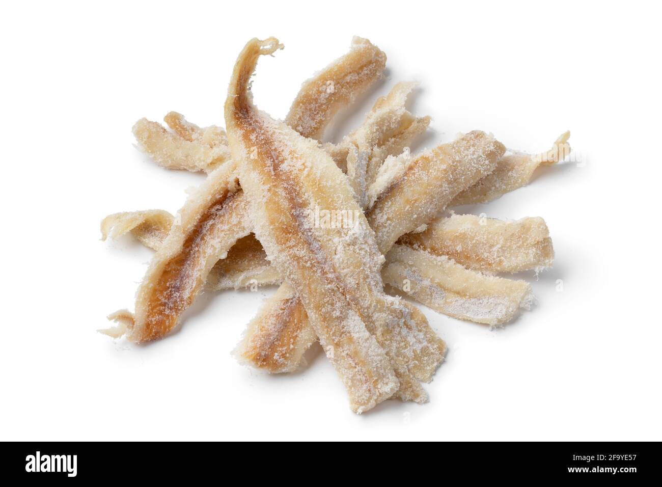Heap of dried and salted cod fillets close up isolated on white background Stock Photo