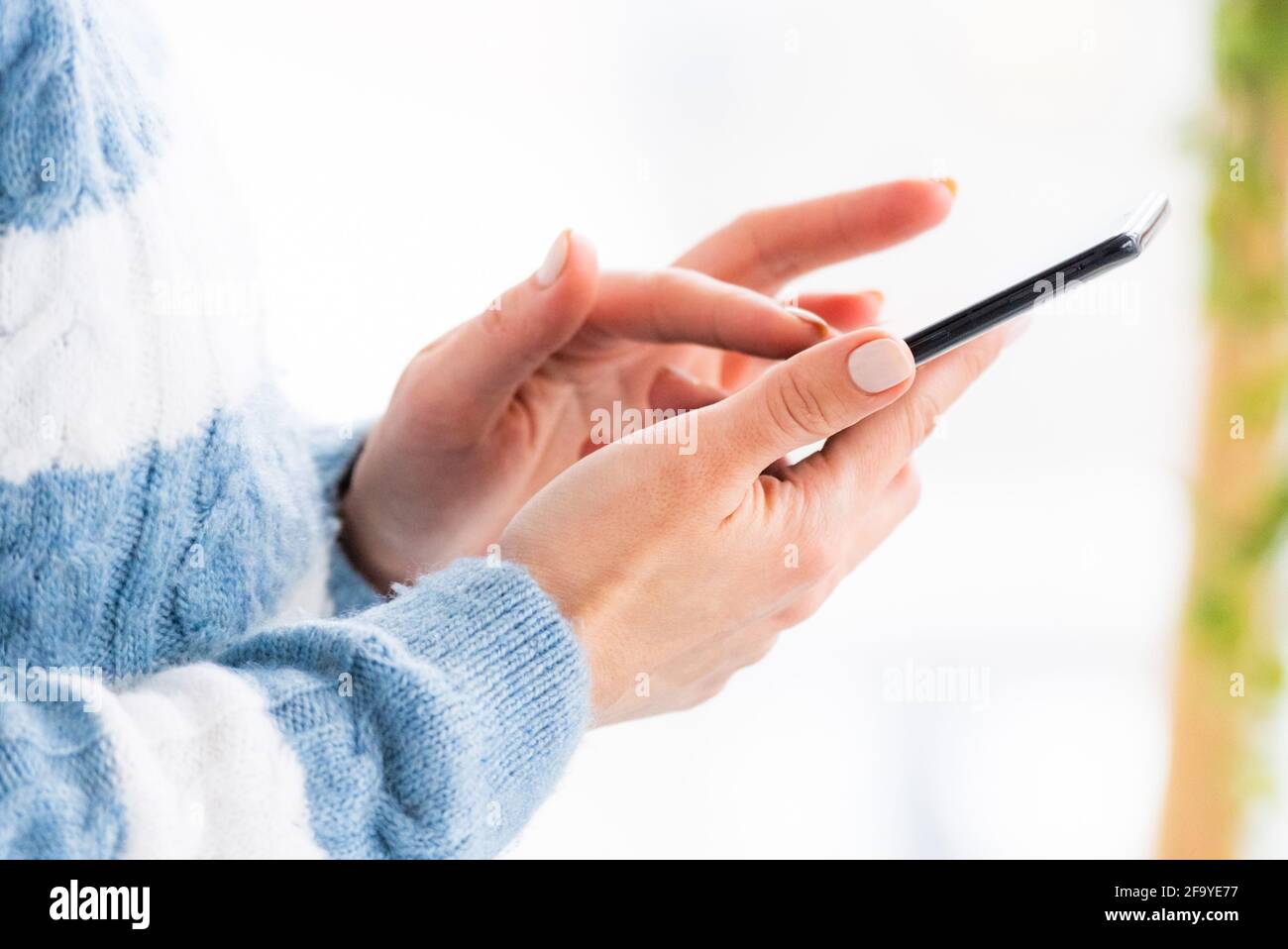 Female hands using mobile phone close up Stock Photo