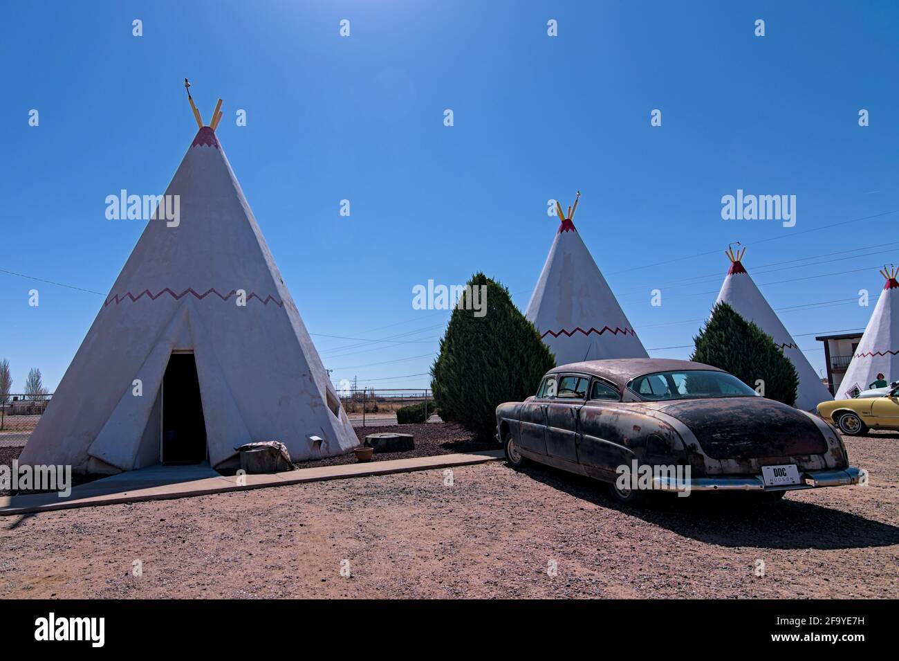 HOLBROOK, Arizona USA - April 4, 2021: Wigwam hotel on Route 66 where guests can sleep in teepee wigwam among parked classic cars. Stock Photo