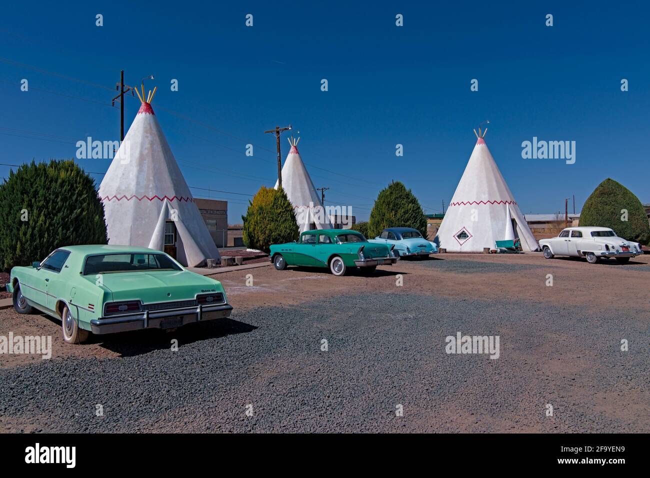 HOLBROOK, Arizona USA - April 4, 2021: Wigwam hotel on Route 66 where guests can sleep in teepee wigwam among parked classic cars. Stock Photo
