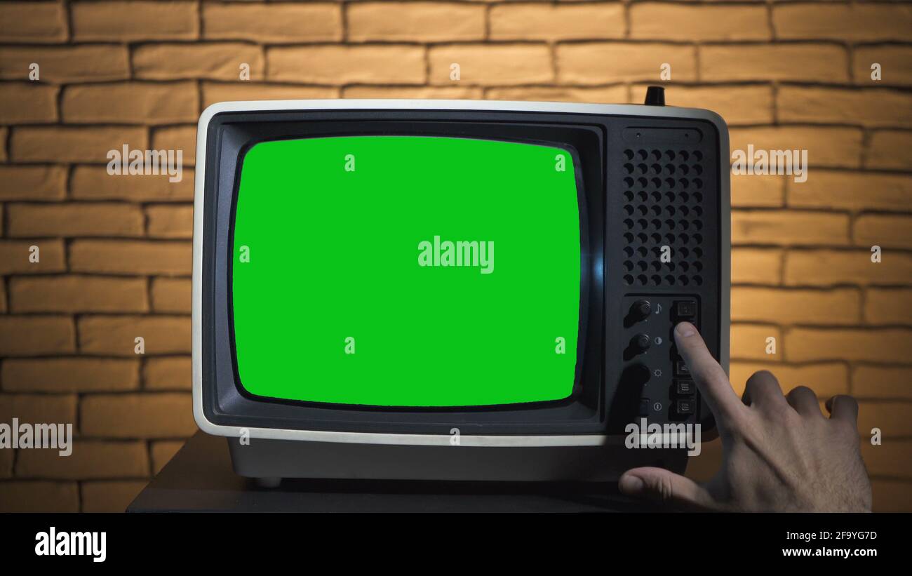 Photo of turning on the retro tv with green screen Stock Photo Alamy