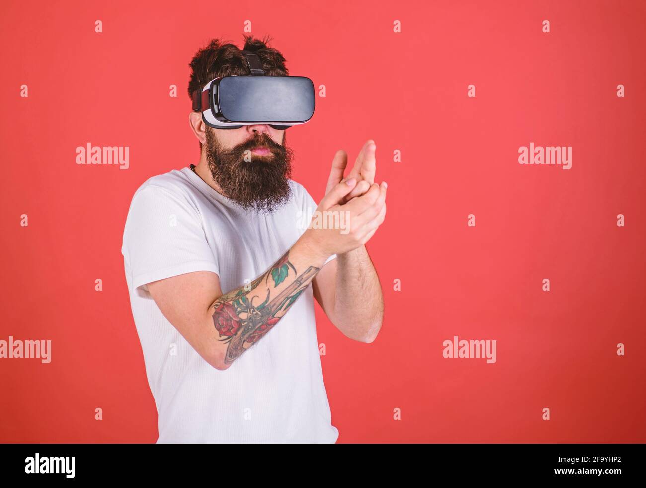 Virtual shooting gallery concept. Hipster on busy face play in virtual reality. Guy with head