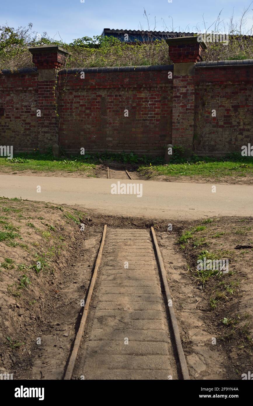 Military Narrow Gauge Railway now covered by footpath and a wall, New Walk, next to the river Ouse, York, North Yorkshire Stock Photo