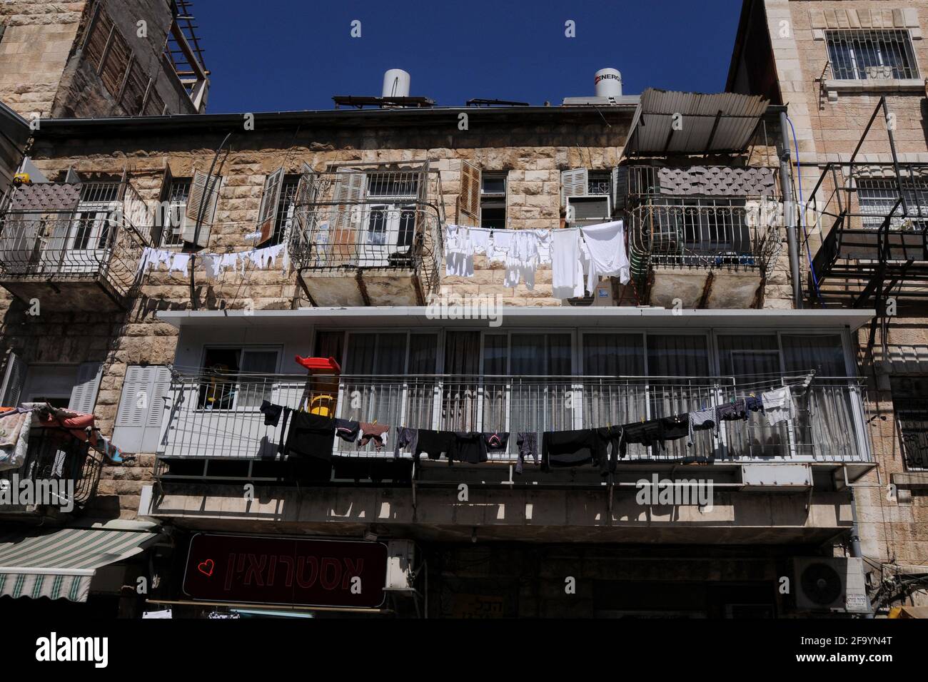 Jerusalem Light and dark laundry drying on a clothesline on balcony