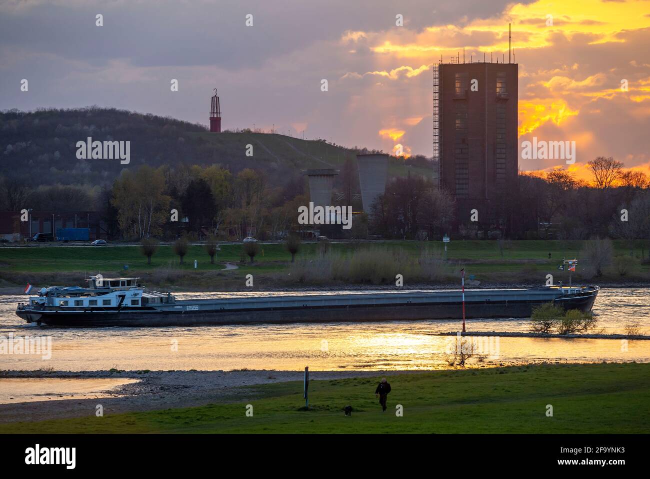 Cargo ship on the Rhine near Duisburg-Beeckerwerth, Rheinpreussen slagheap in Moers, slagheap sign Das Geleucht, winding tower of the former Rheinpreu Stock Photo