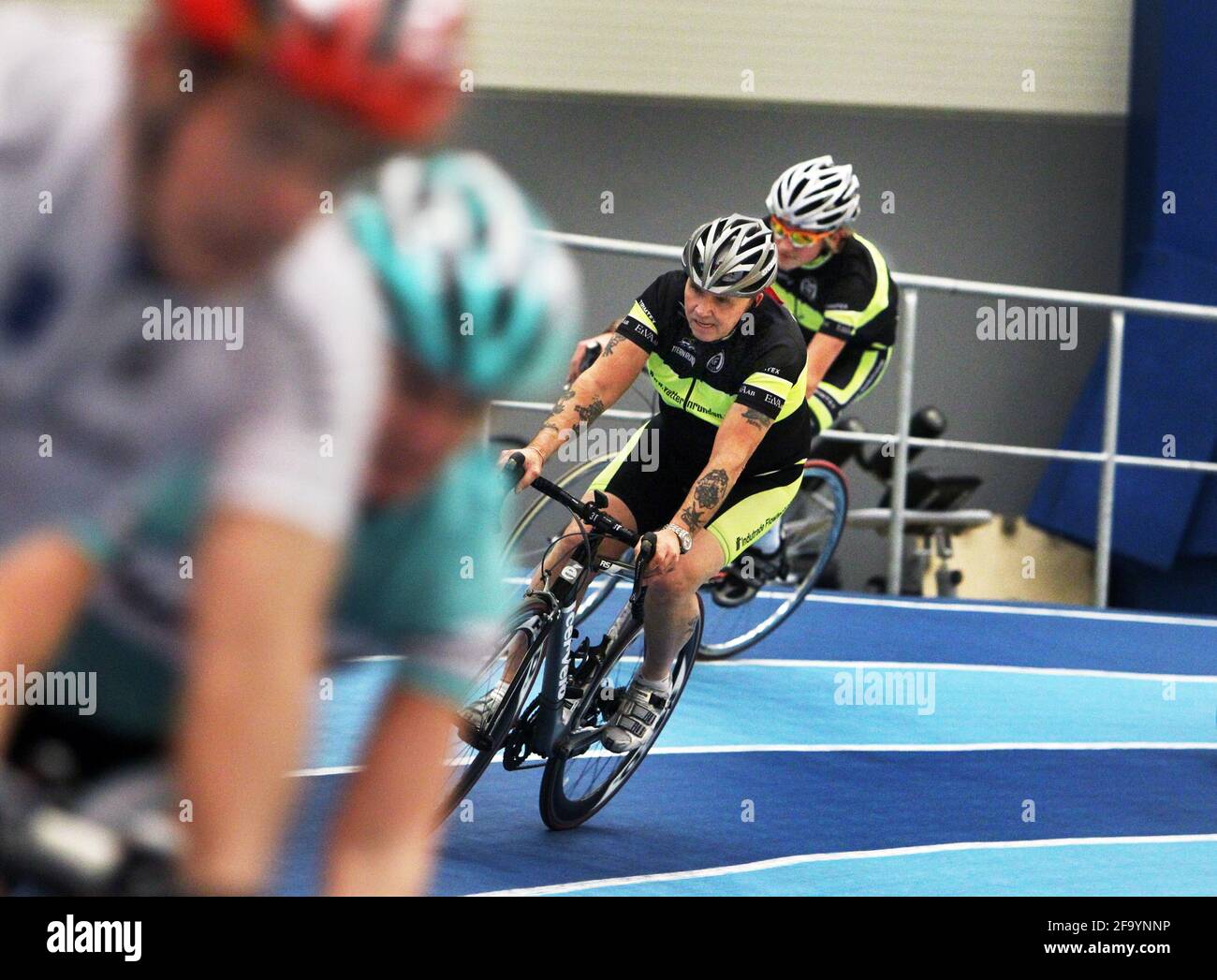 Someone who does cycling training on a running track indoors Stock