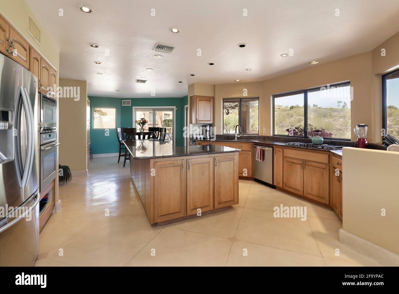 Kitchen in luxury home with center island and eating area Stock Photo