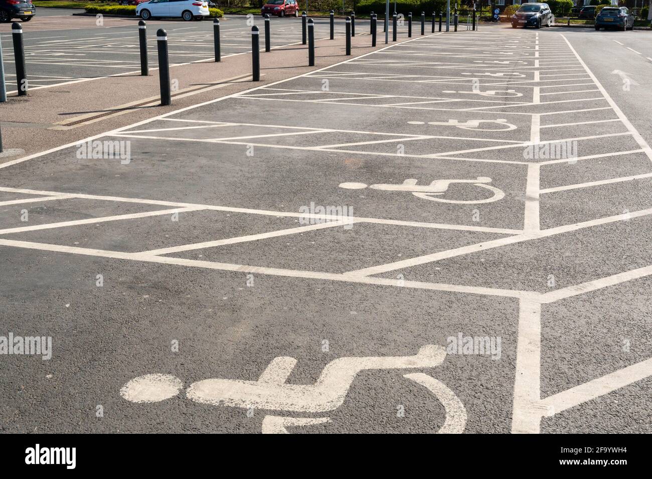 Disabled parking space or bay,reserved for people with disabilities and extra space for loading a wheel chair at a car park for a superstore Stock Photo