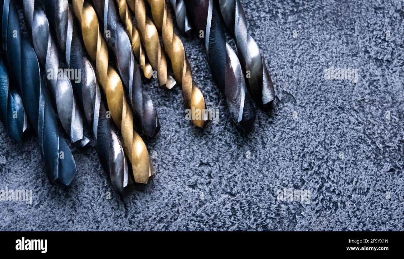 Set of drill bits on grey background Stock Photo