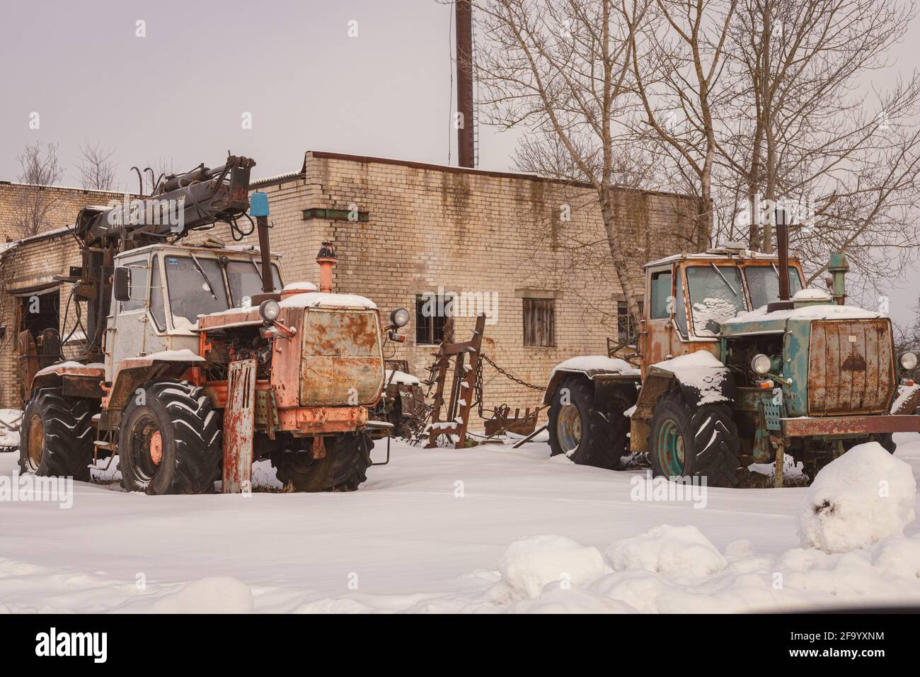 old rusty abandoned tractors in winter Stock Photo