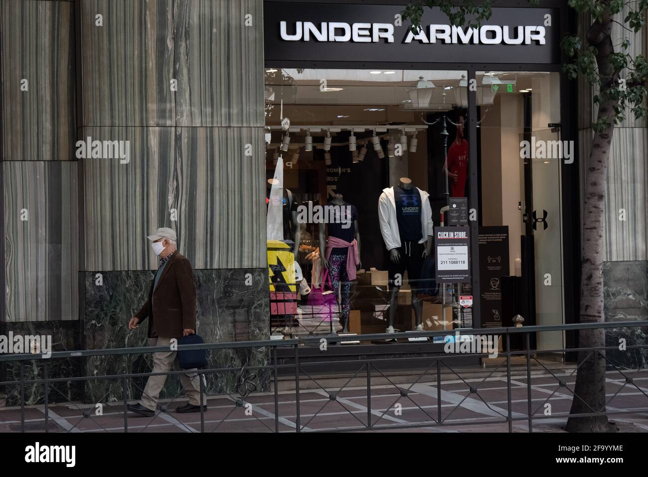 Athens, Greece. 21st Apr, 2021. A man walking past the Under Armour store  at Syntagma square. (Photo by Nikolas Joao Kokovlis/SOPA Images/Sipa USA)  Credit: Sipa USA/Alamy Live News Stock Photo - Alamy