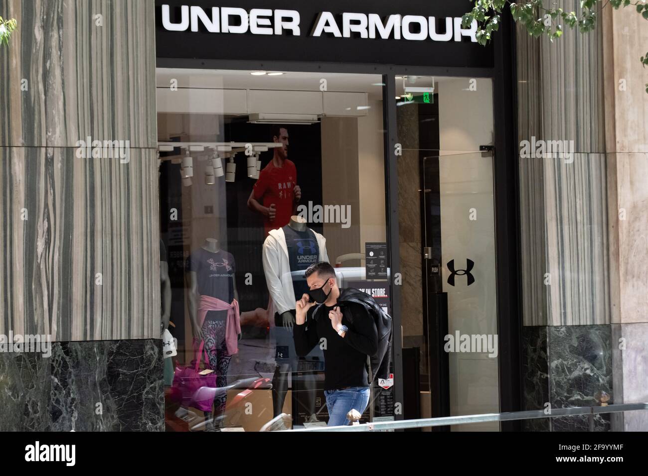 Athens, Greece. 21st Apr, 2021. A man walking past the Under Armour store  at Syntagma square. (Photo by Nikolas Joao Kokovlis/SOPA Images/Sipa USA)  Credit: Sipa USA/Alamy Live News Stock Photo - Alamy