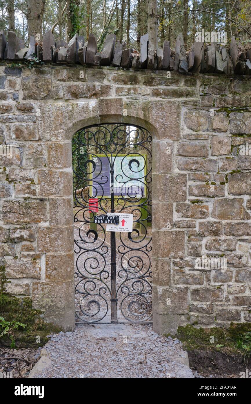 An ornate iron gate gives access to the Wales Coast Path and Glan Faenol wildlife and woodland walk. Stock Photo