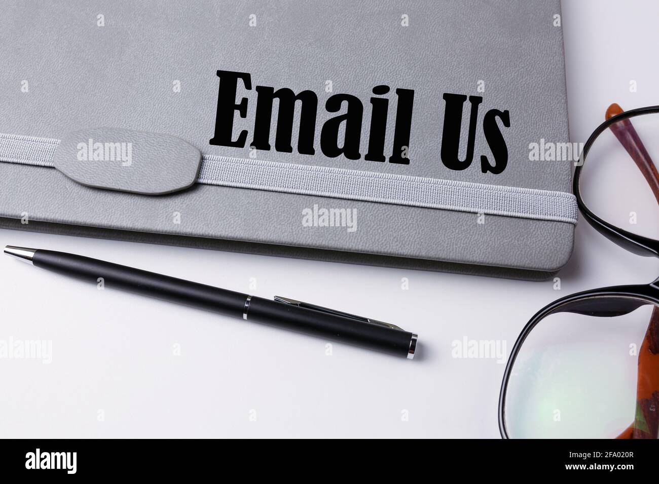 Email us written on a notebook. Stock Photo