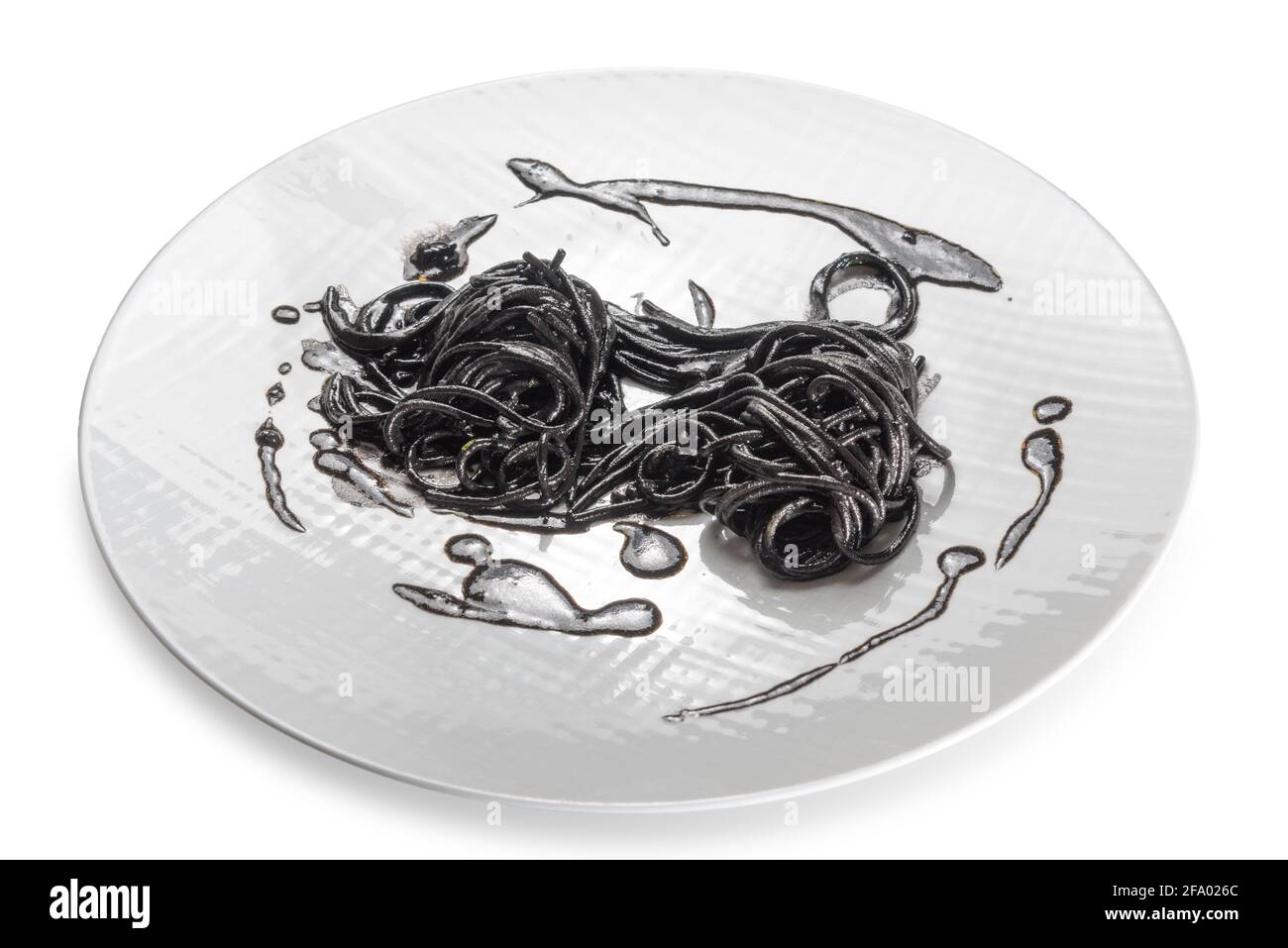 Black pasta squid ink - italian tagliatelle al nero di seppia - close up in a white dish isolated on white Stock Photo