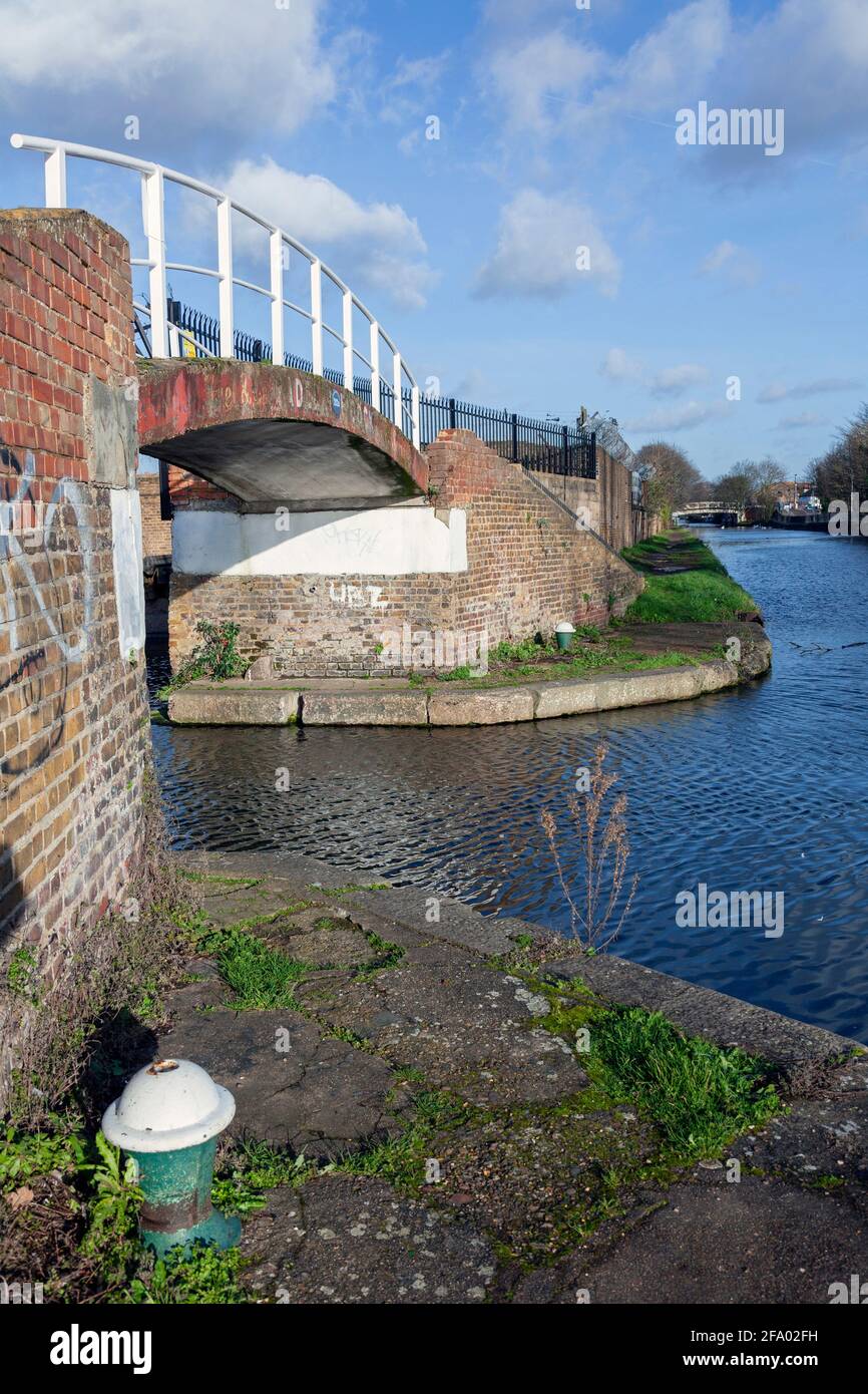 UK, England, London, Southall, Arched Bridge taking the Towing Path across the entrance to Adelaide Dock Stock Photo