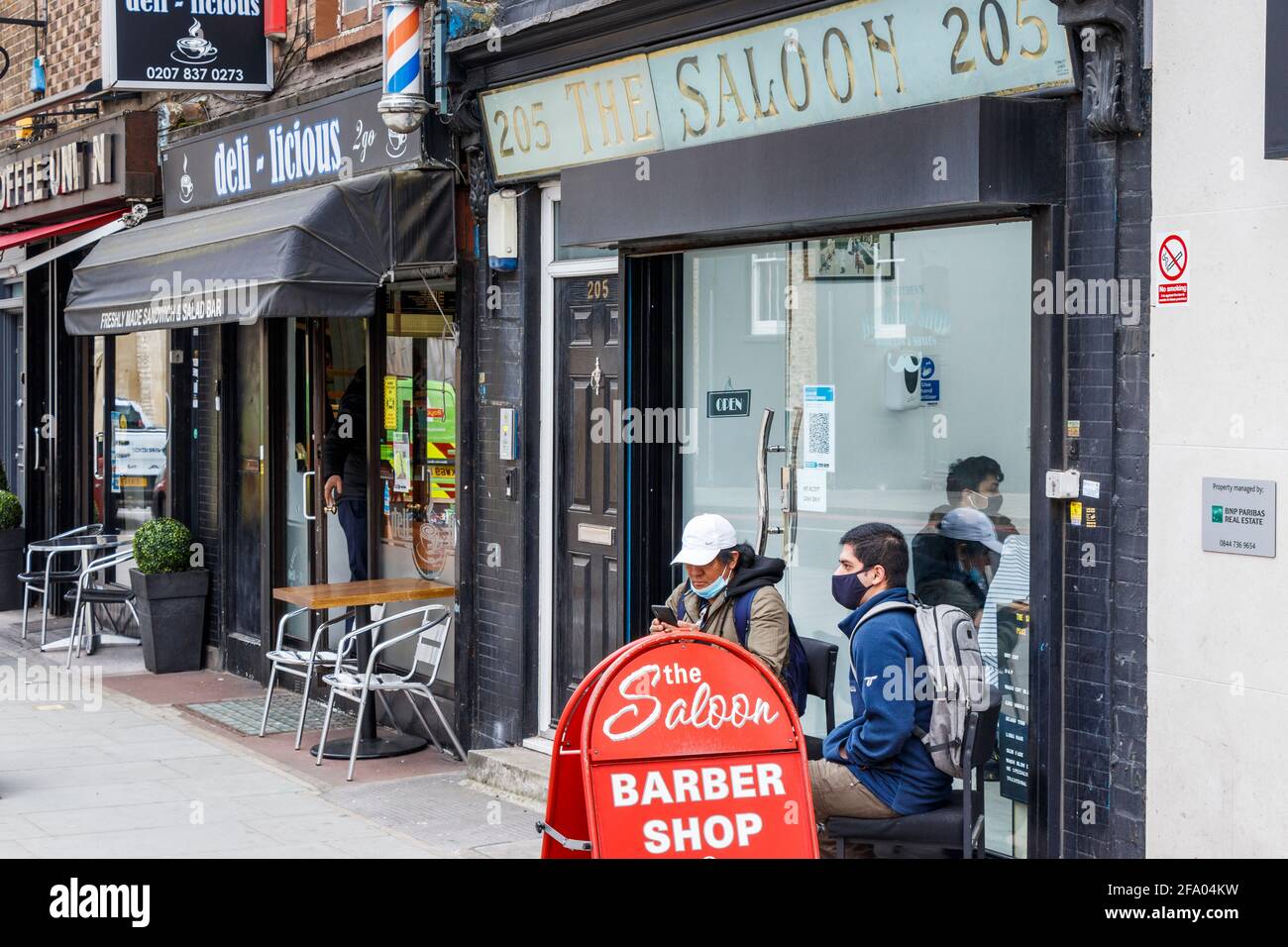 Customers waiting outside The Saloon, a barber shop on King's Cross