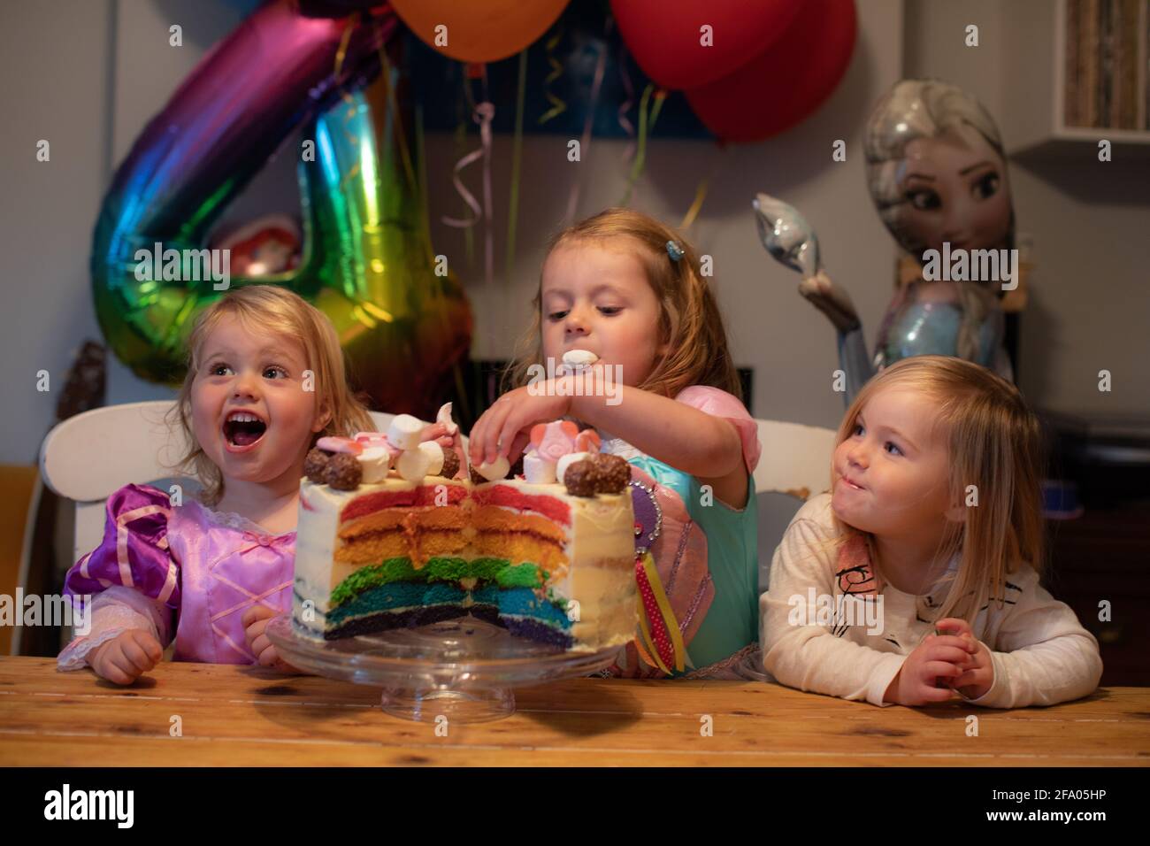 Young sisters celebrating a birthday at home during lockdown, UK Stock Photo